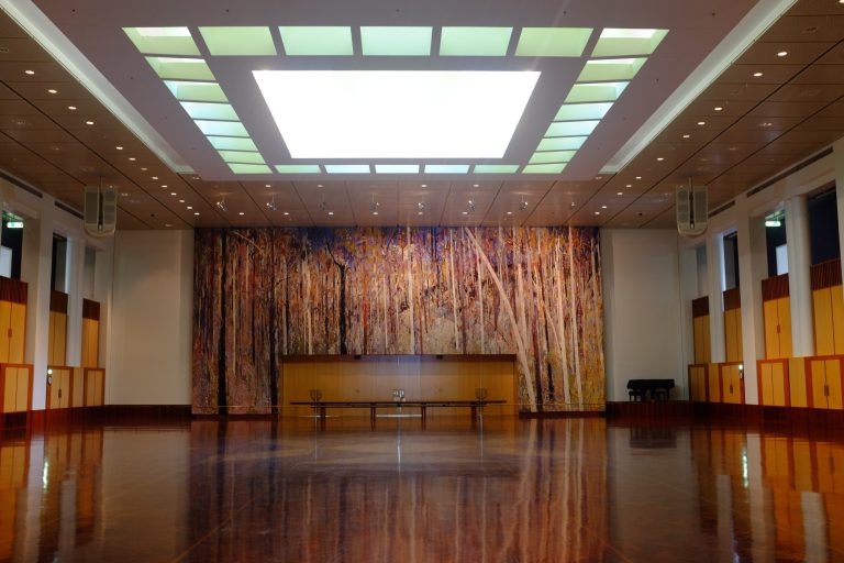 great hall with with designed tapestry in backround