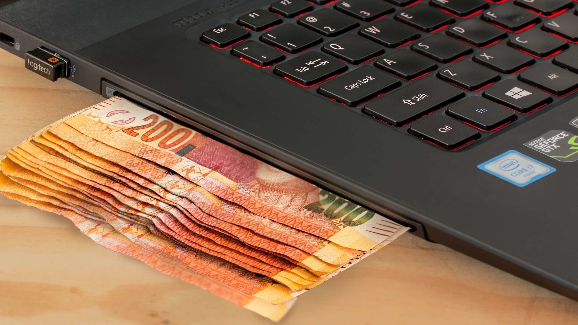laptop with currency underneath