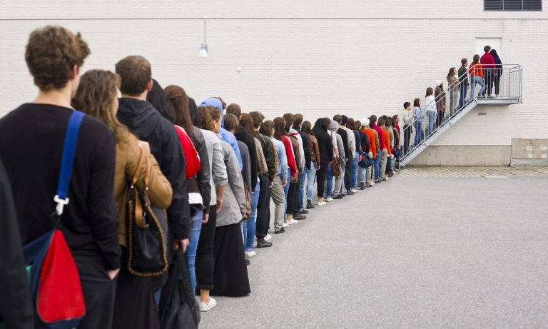 line of people waiting to enter a building