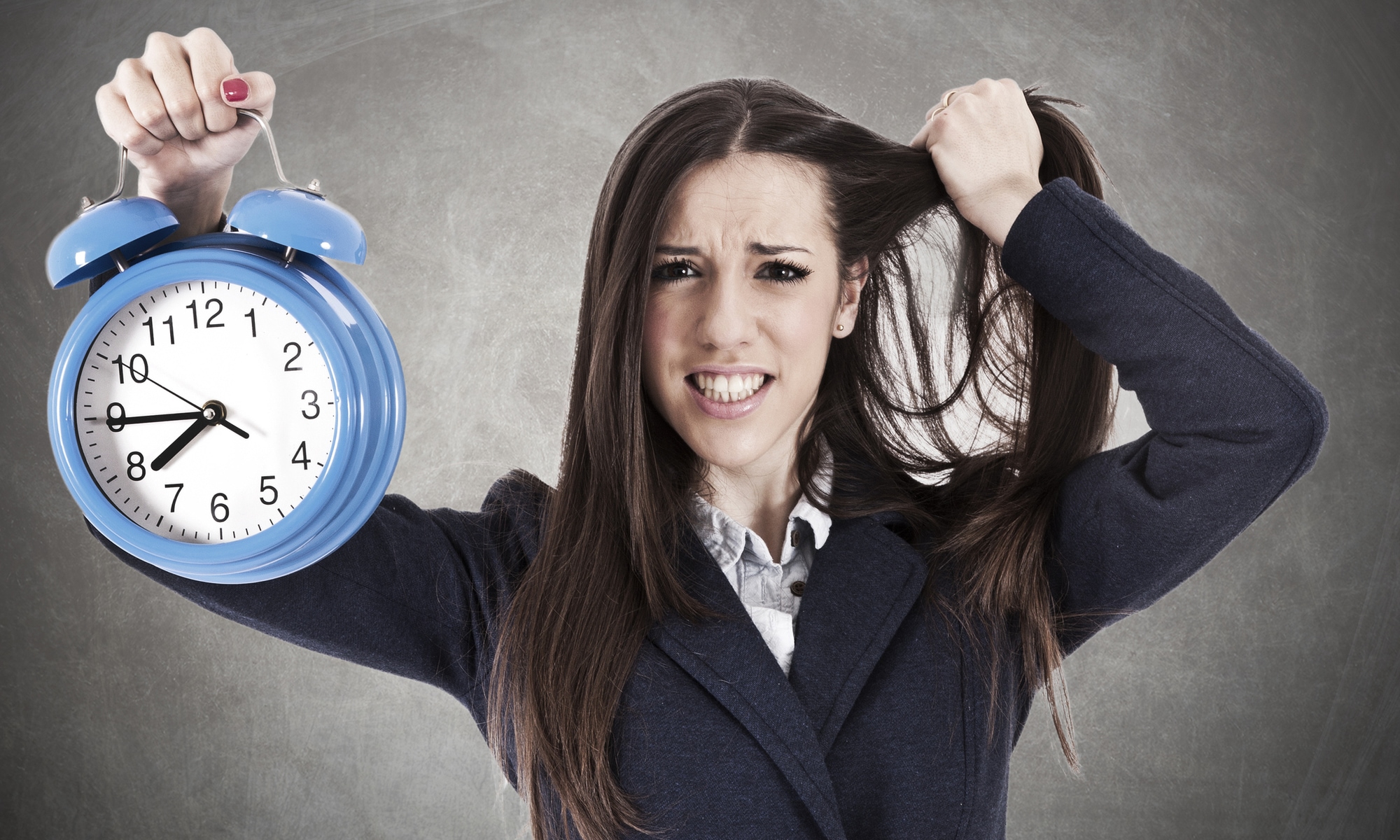 woman holding clock and tearing hair